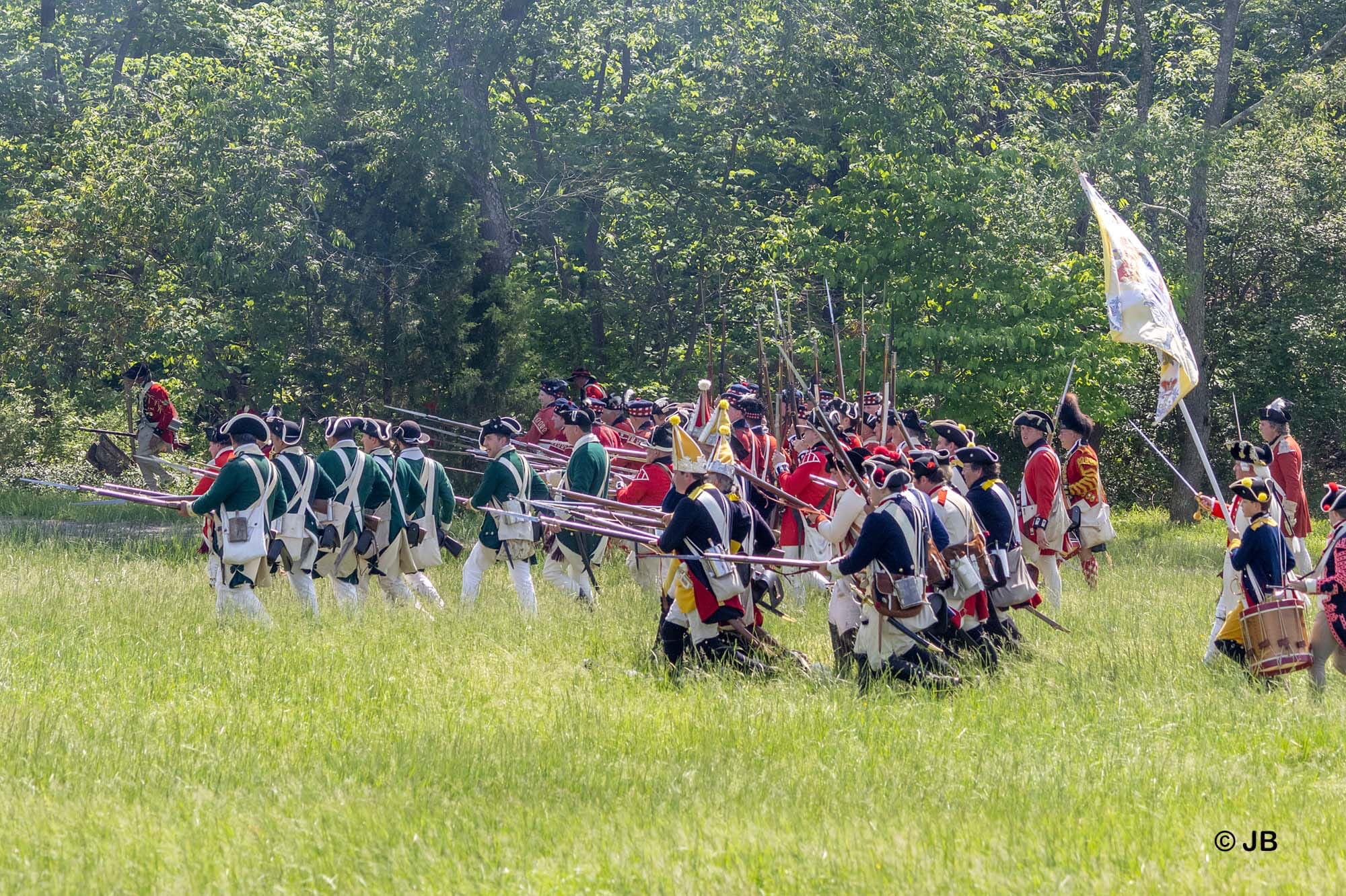 Revolutionary War soldiers marching in a field.