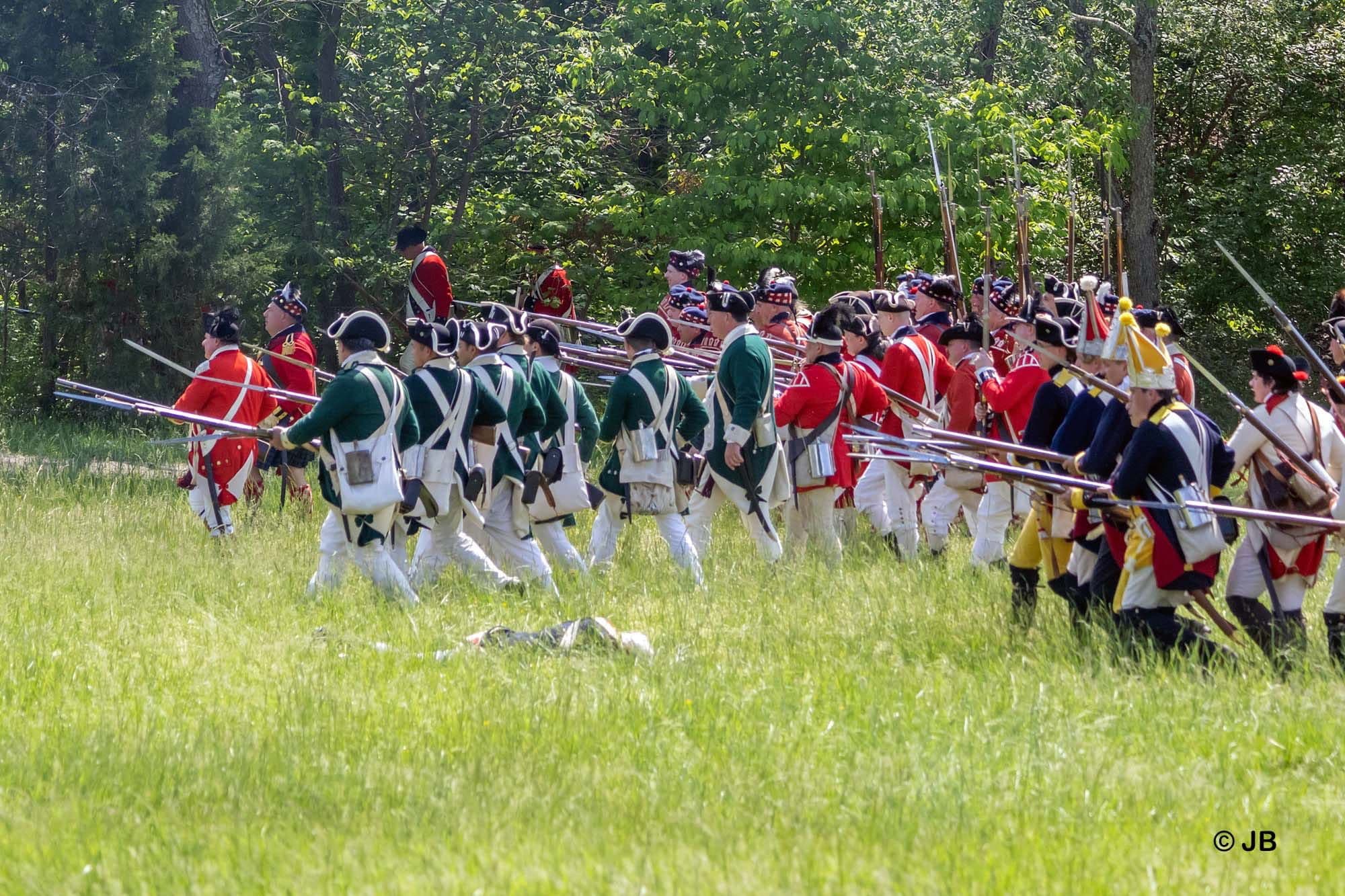 Revolutionary War soldiers marching in a field.